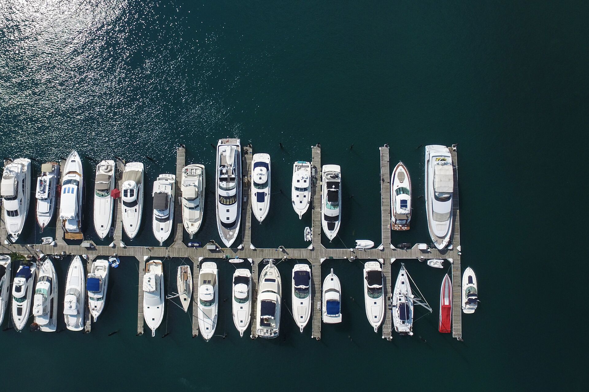 Overhead view of boats lined up at a dock, buying a boat concept. 