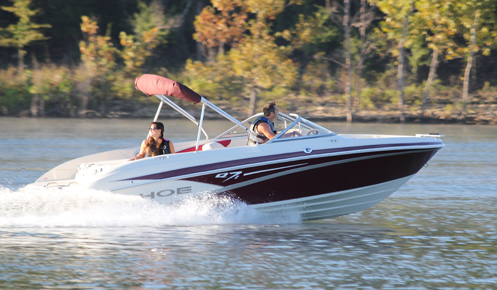 A man and woman on a boat, do you need a driver's license to drive a boat concept. 