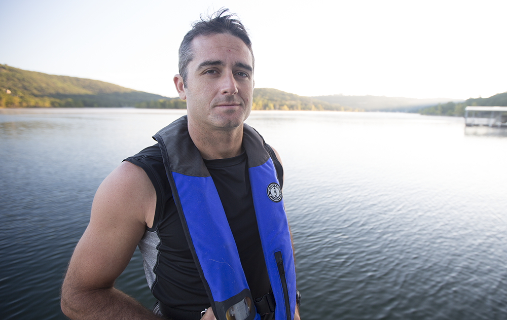 A man in a life jacket on the water. 